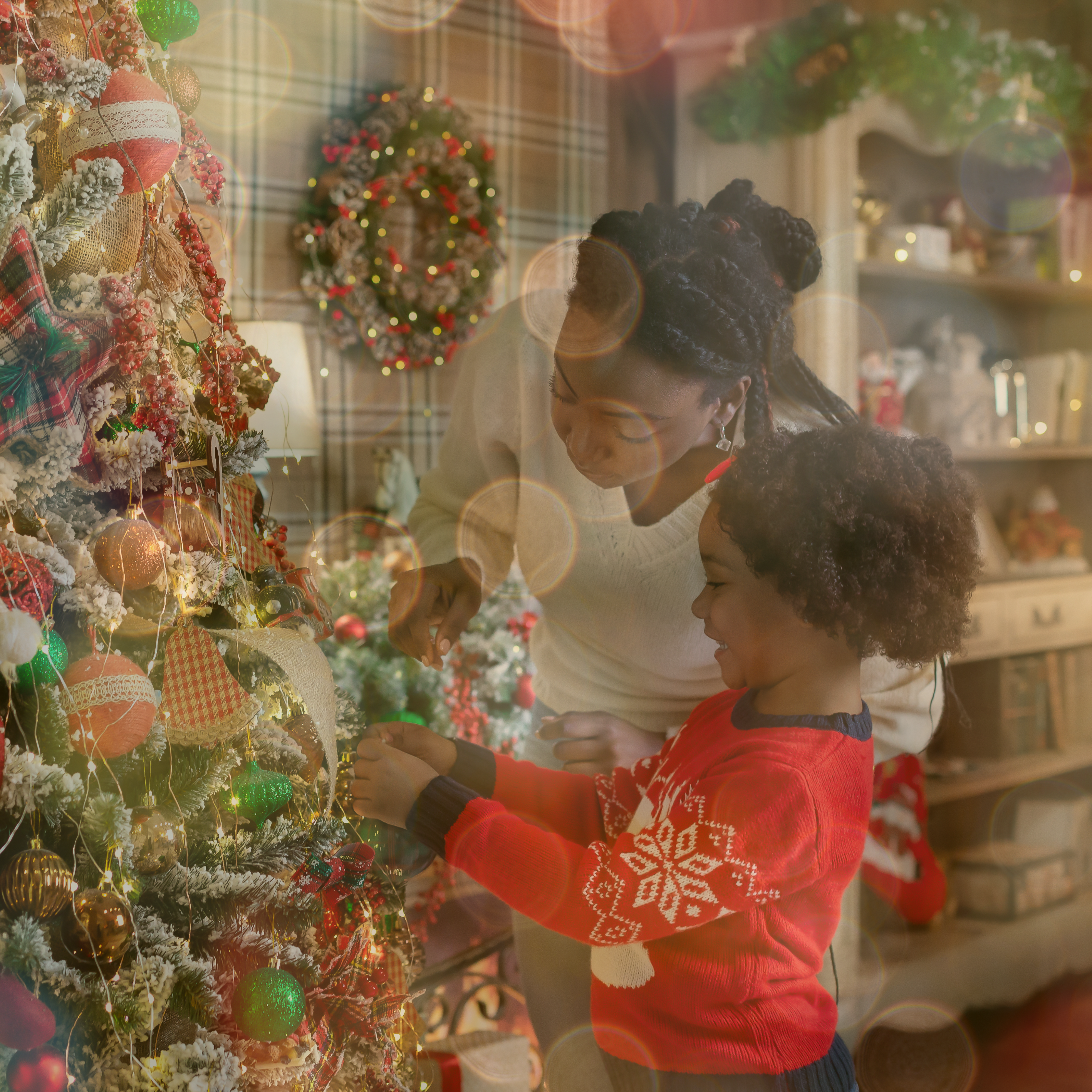 Mother and Daughter decorating a christmas tree